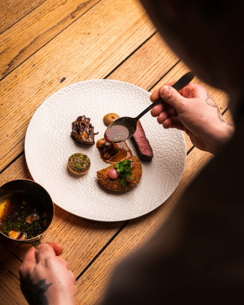 A retired-dairy-cow beef dish, richly plated, at The Peacock Inn