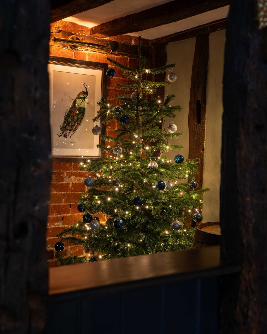 The private dining room at The Peacock Inn, with beams and a table laid for dinner