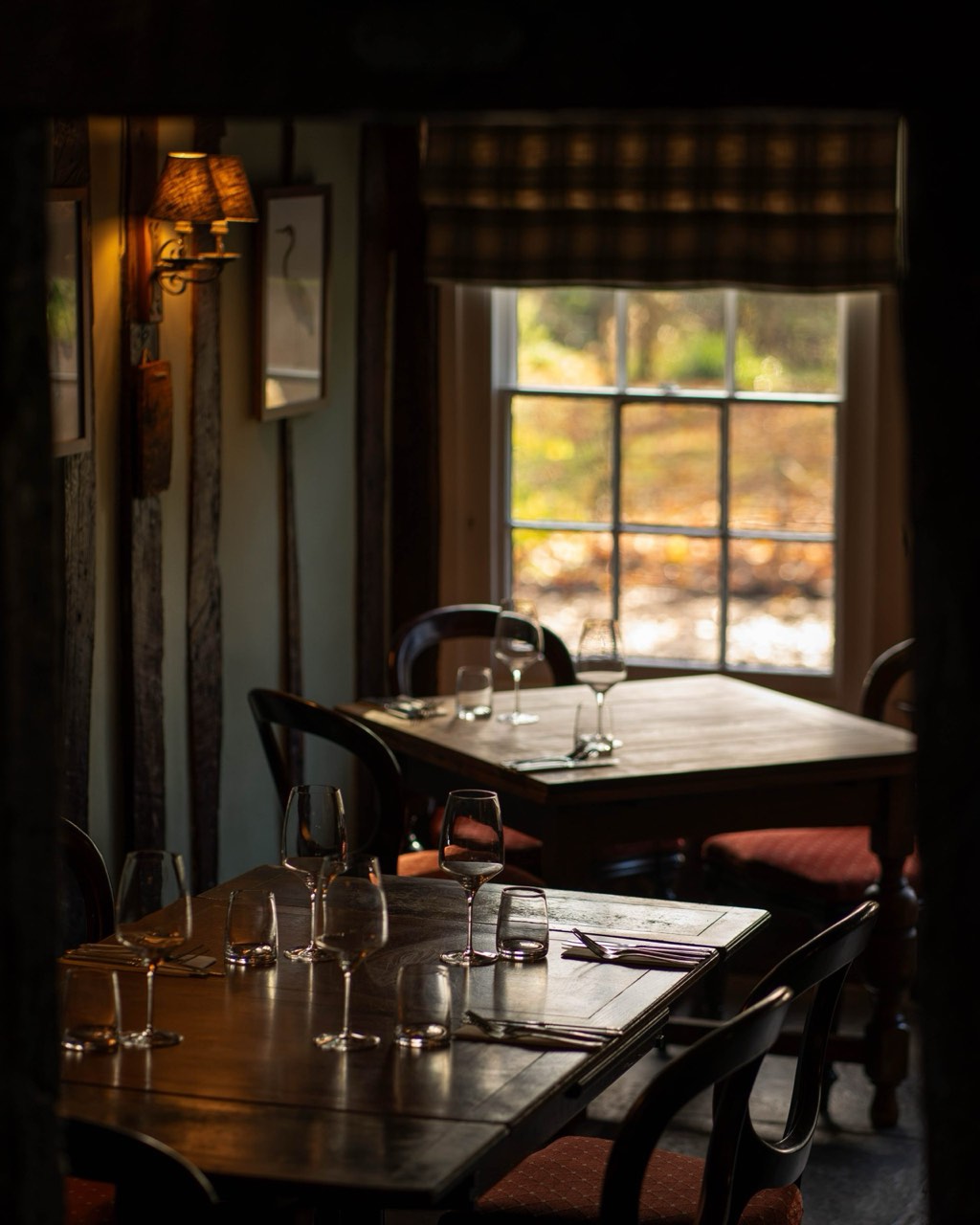 A warm, beamed corner of The Peacock Inn with relaxed country furnishings — a quiet base for exploring Suffolk