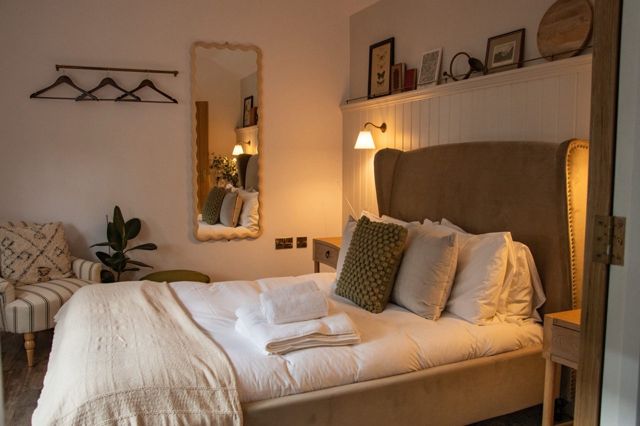 A calm garden bedroom at The Peacock Inn made up for an overnight stay