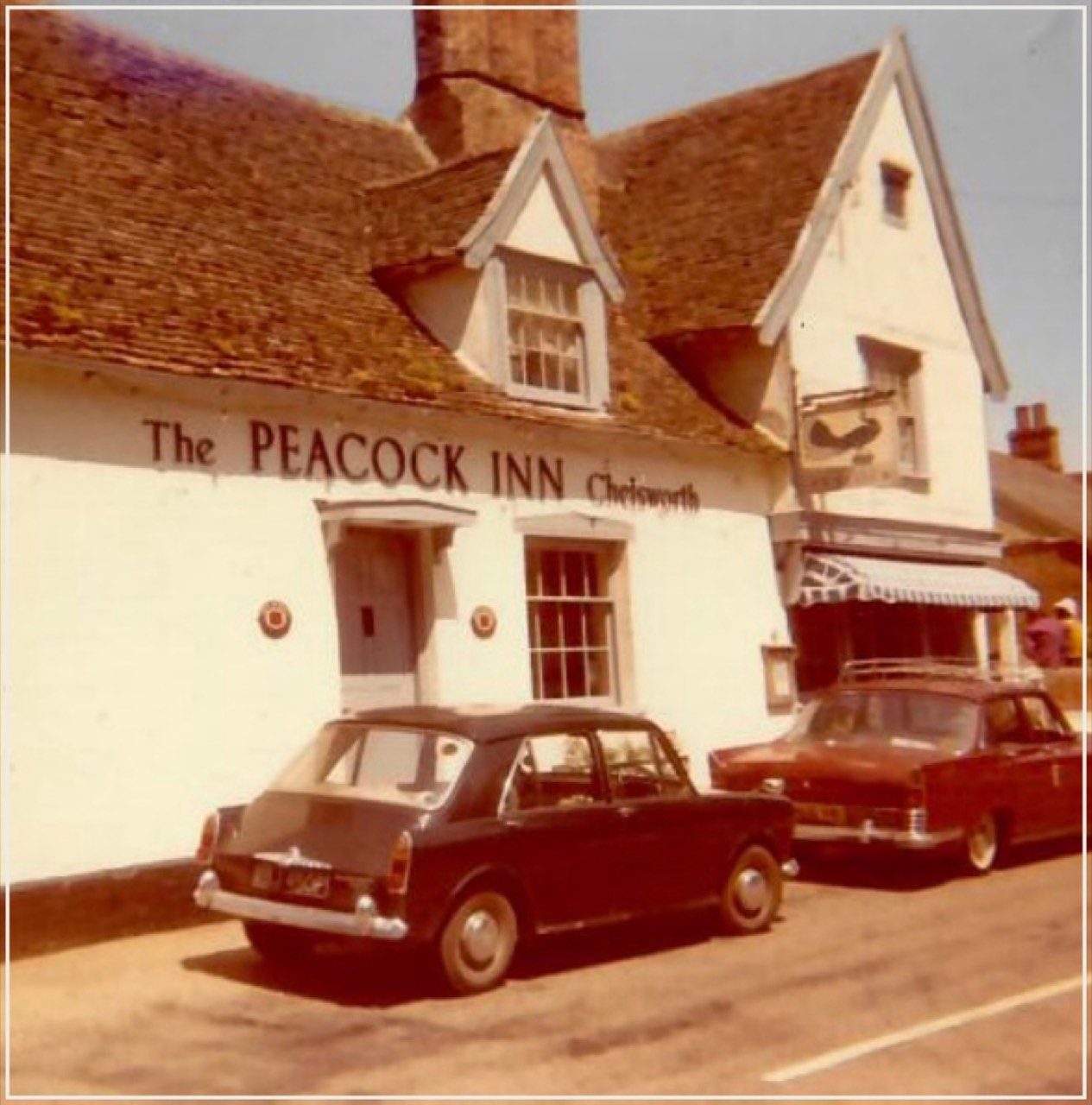 A scanned, framed historic photograph of the front of The Peacock Inn, Chelsworth — its half-timbered 14th-century façade as it has stood for generations